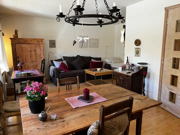 Studio table and chairs underneath ornate chandelier